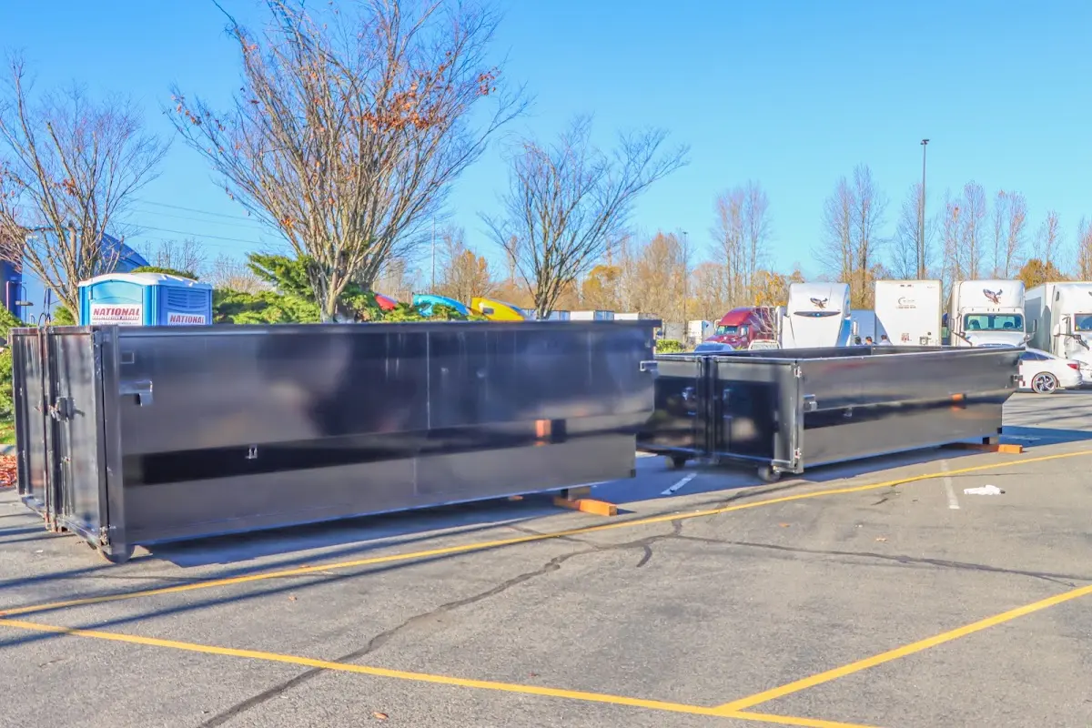 Professional dumpster rental service with roll-off container on residential driveway in Palos Hills